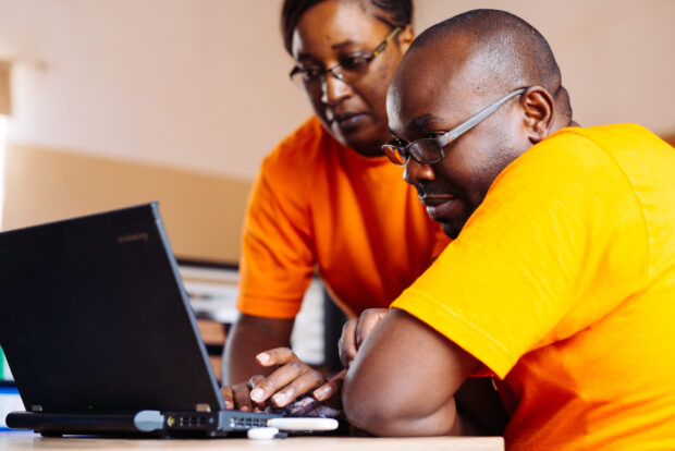 Man and woman looking at laptop