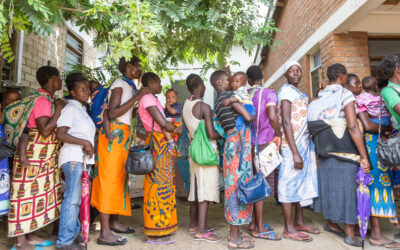 Women queueing in Africa with children