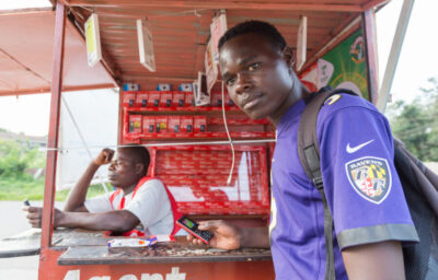 Man at outdoor phone kiosk store